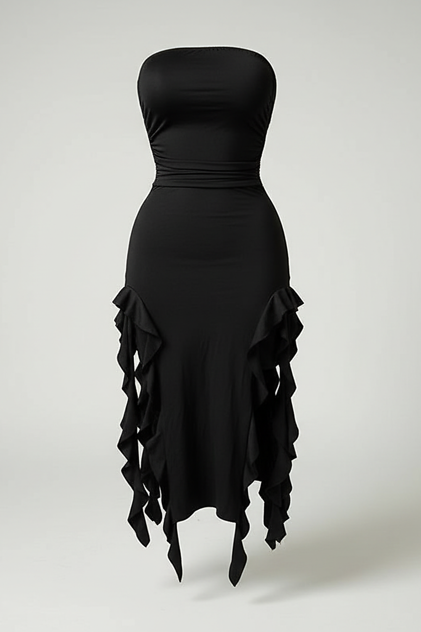 Front view of a model wearing a black strapless bodycon dress with rosette details on the hips and an asymmetrical ruffle hem.; Model wearing the black strapless rosette dress while standing in front