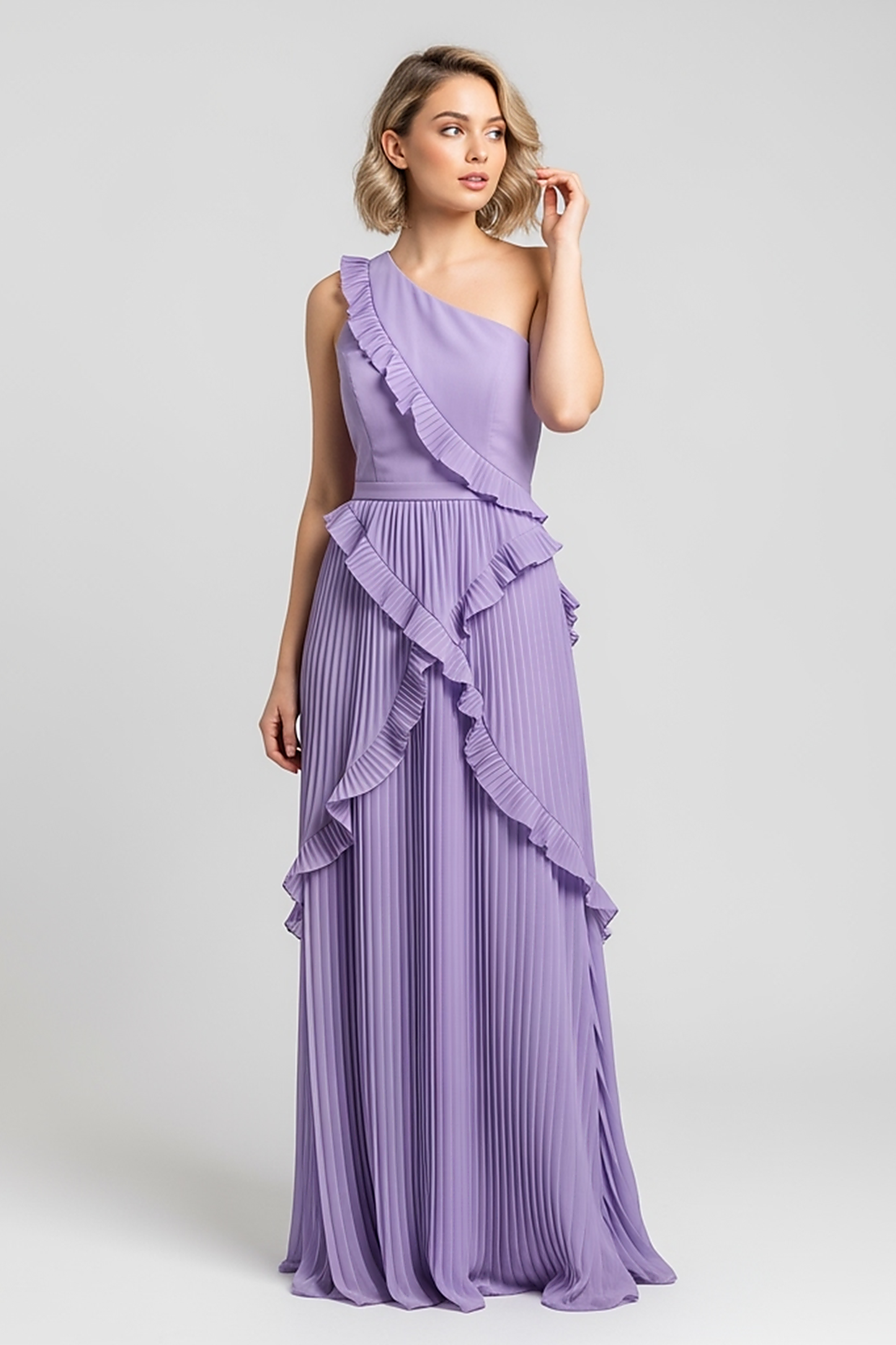 woman wearing black ribbed knit mini dress, front view, standing, hands relaxed