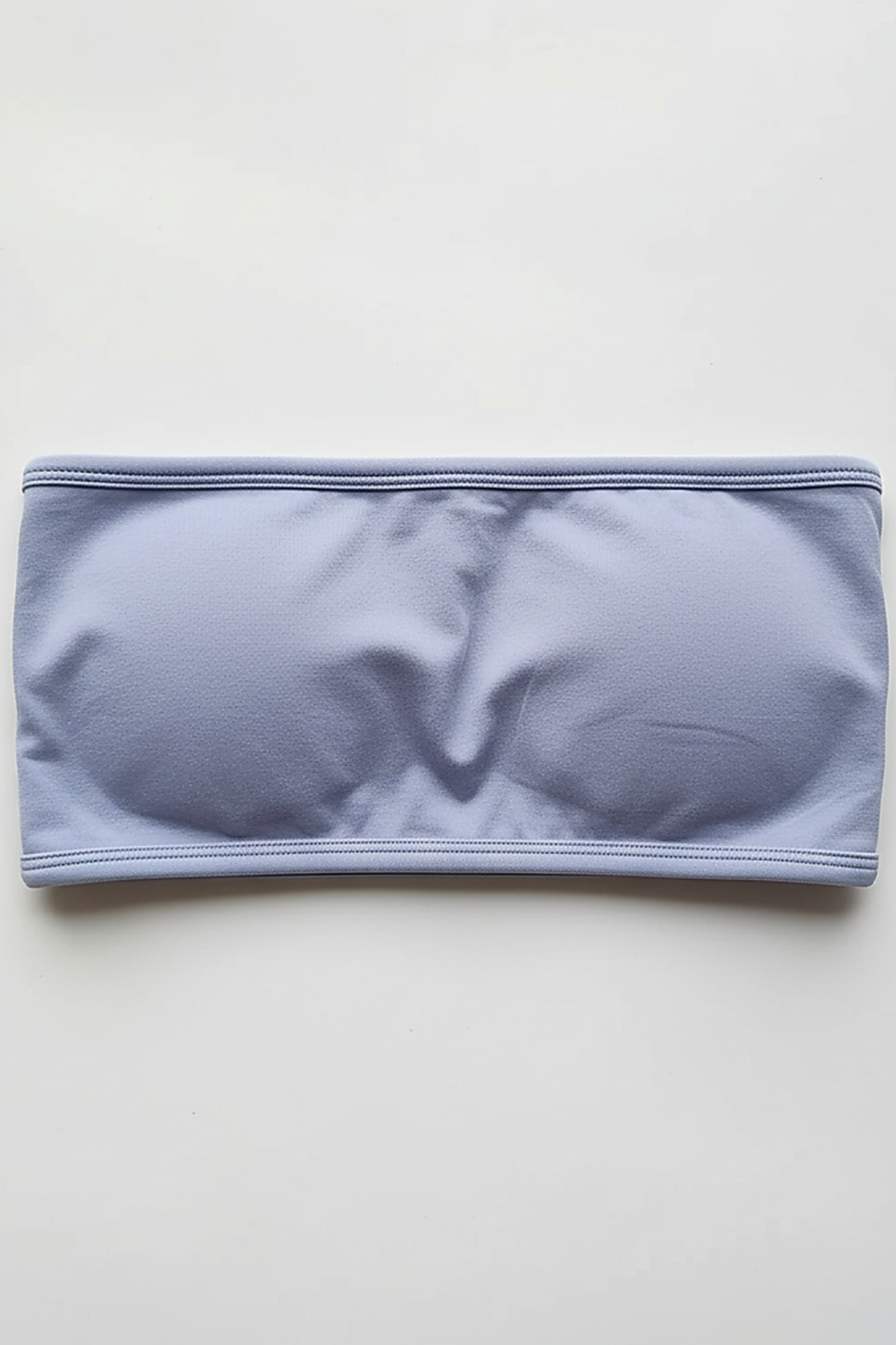 Black backless bandeau sports bra, side view on model.