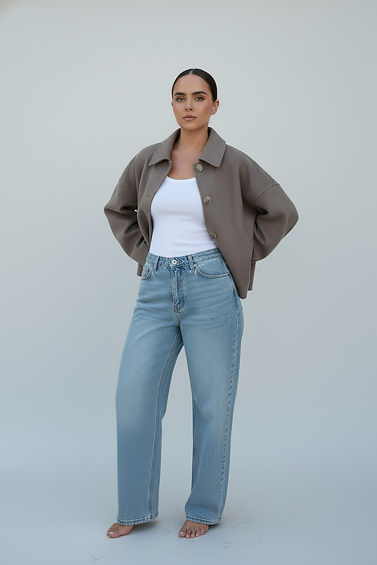 Women's solid wool jacket, side view on model.