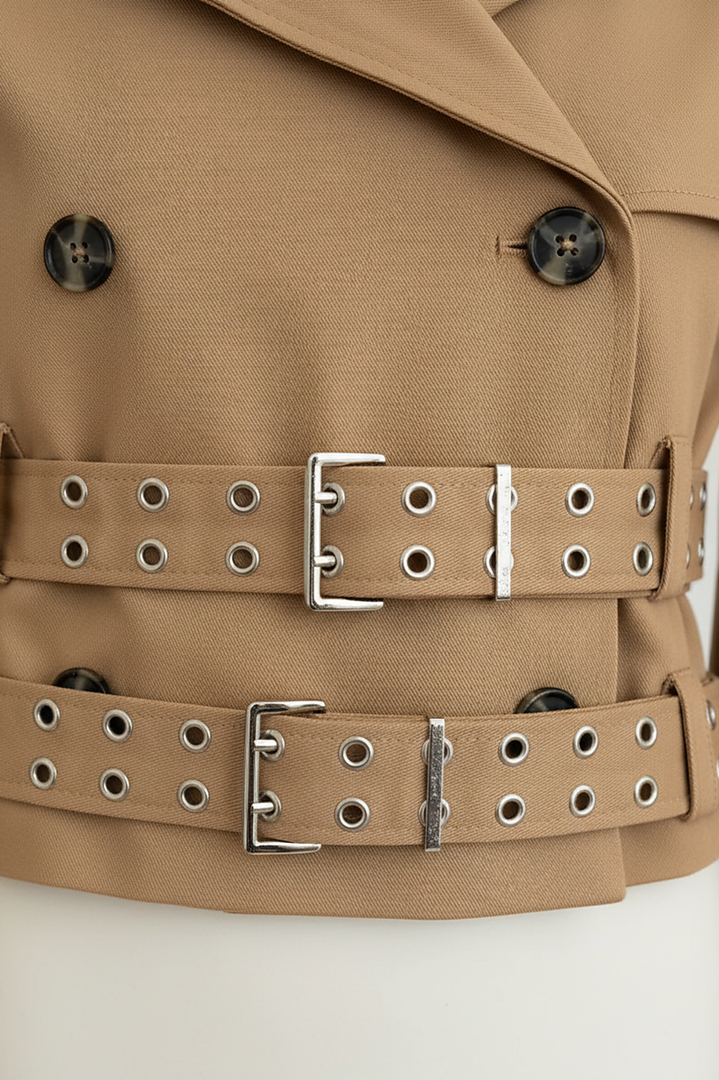 Black hooded crop trench coat, close-up of sleeve.