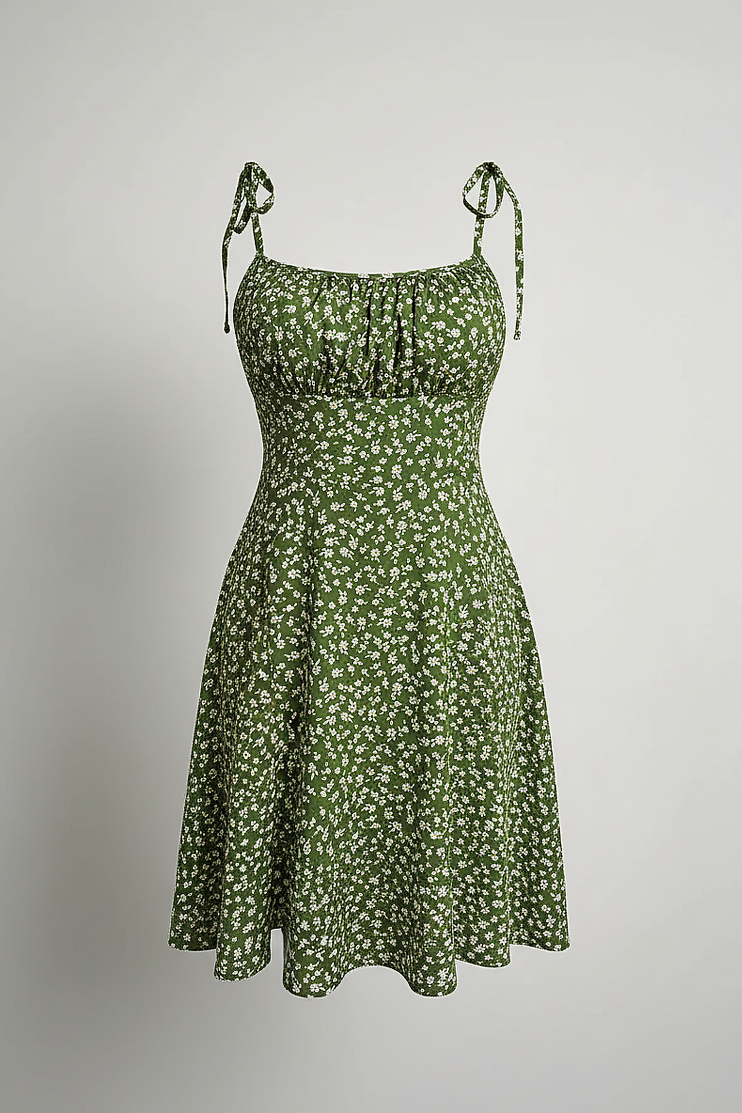 Model with hand on hip wearing a green floral tie-shoulder mini dress against a white background.; Full-length studio shot of a model wearing a green floral spaghetti strap sundress.; Model adjusting