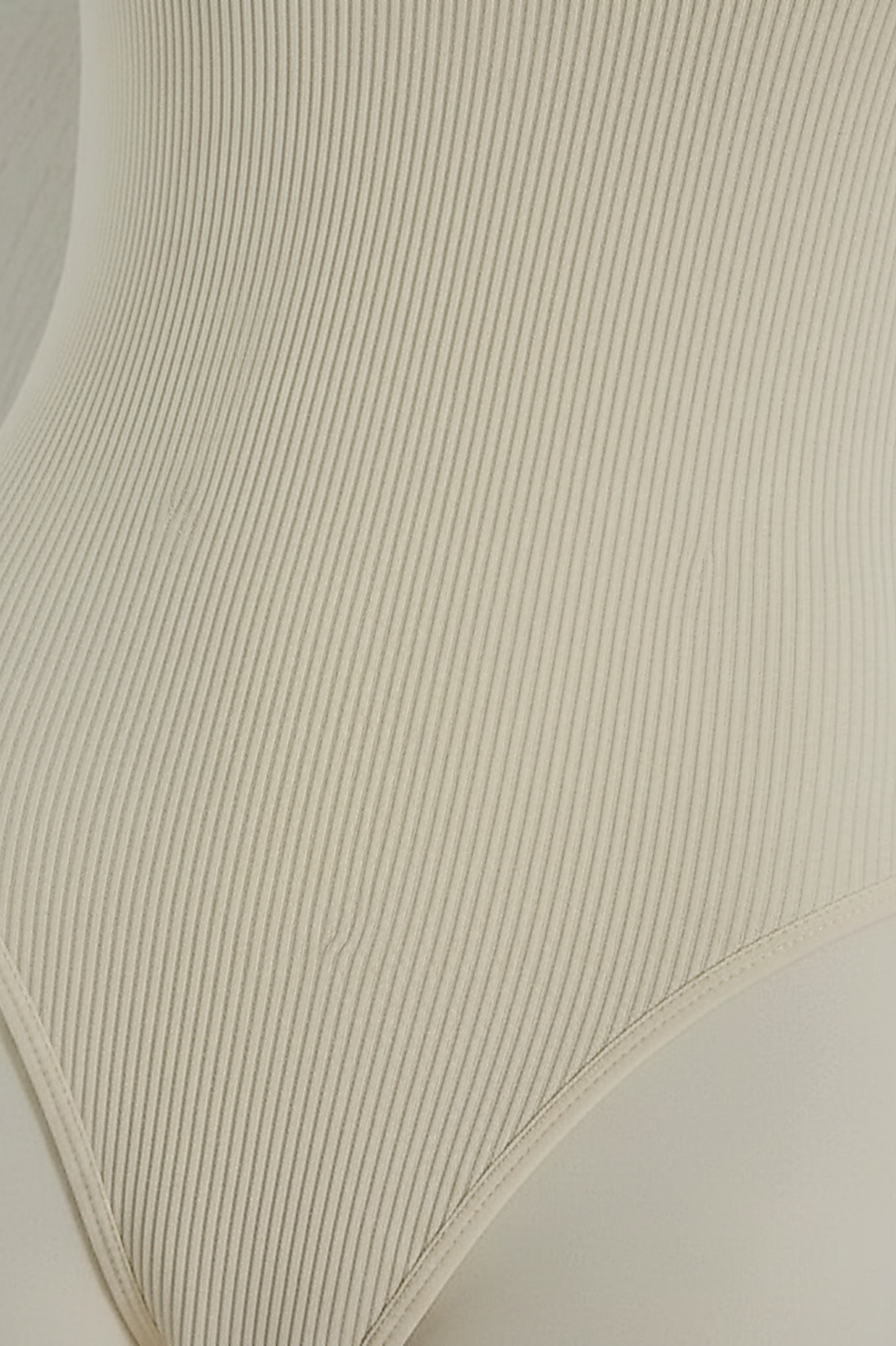 Ribbed jumpsuit fabric, close-up detail.