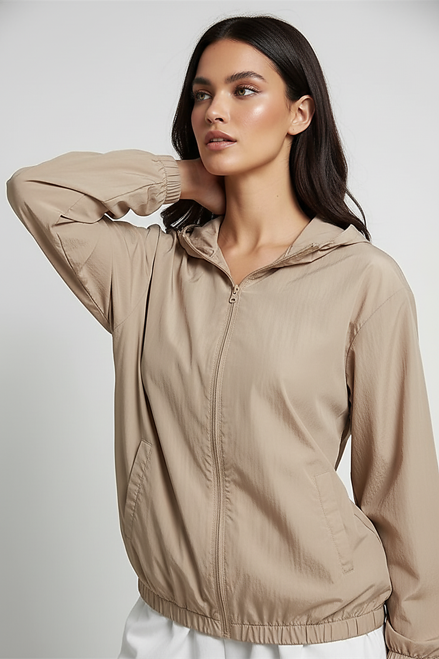 Orange transparent hooded jacket, side view on model.