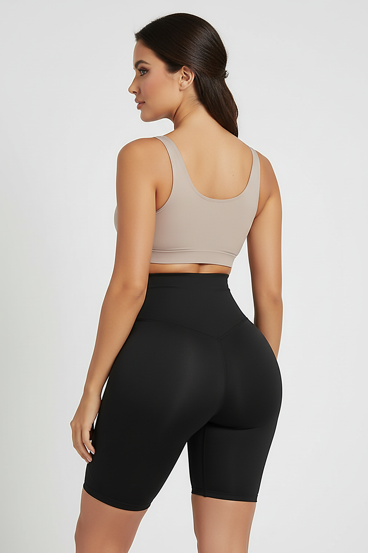 Black padded shapewear shorts, back view on model.