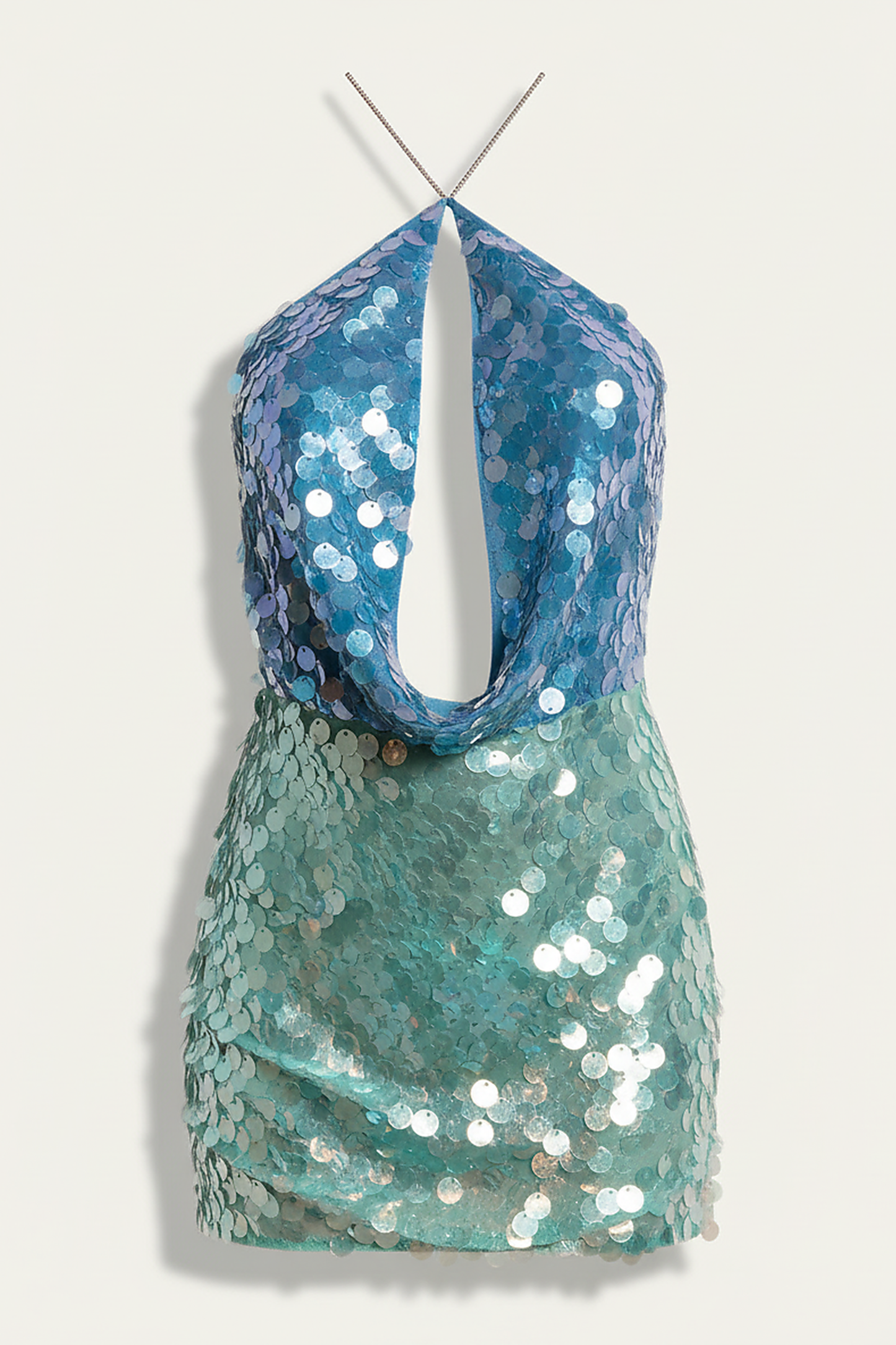 Contrast color sequin halter mini dress with cutout back, on model.