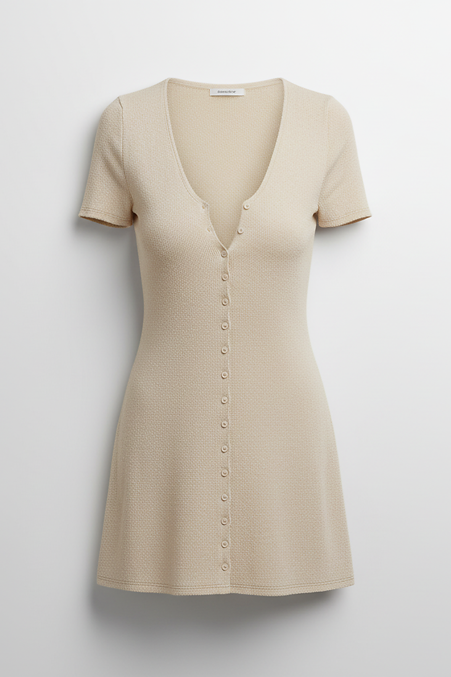 Beige knitted mini dress, front view on model.