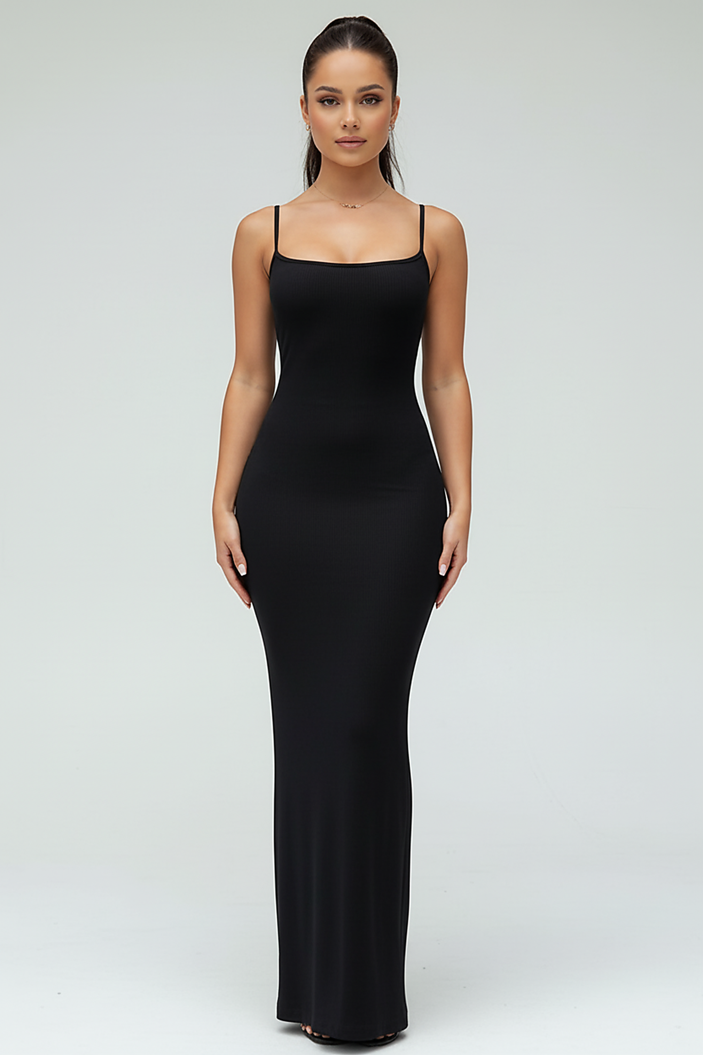 Black spaghetti strap long dress, fabric texture close-up.