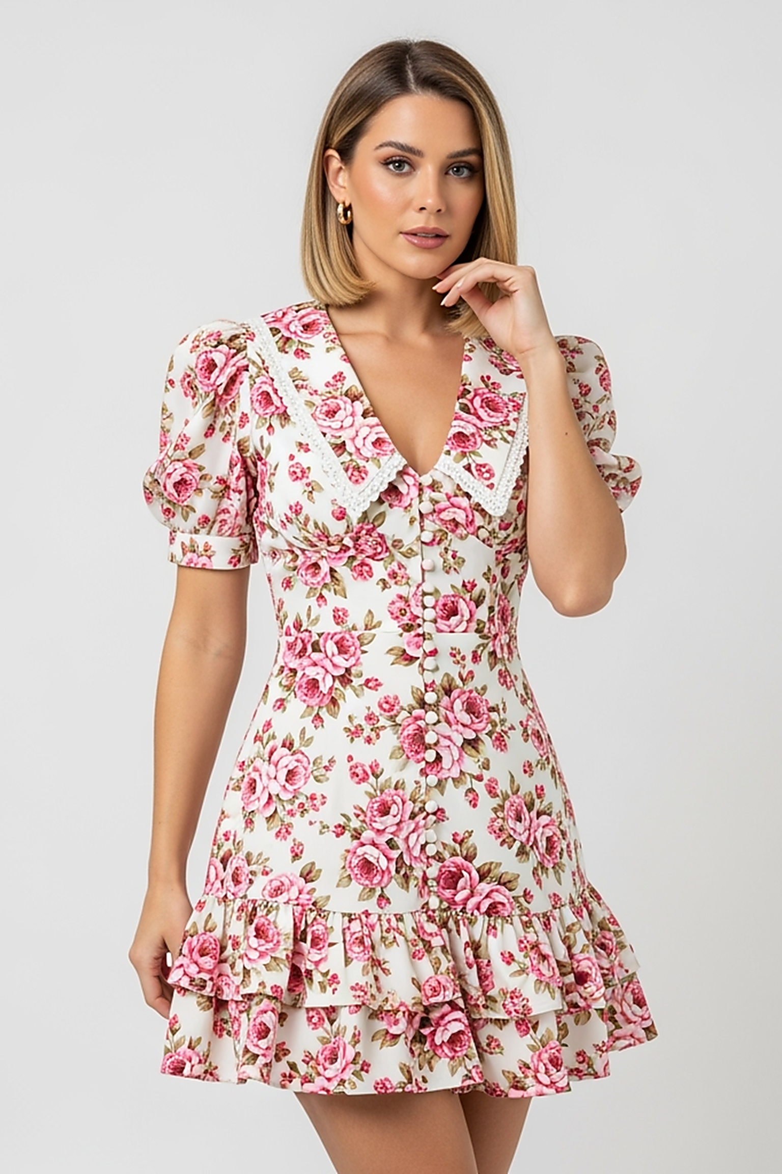 woman wearing floral printed mini dress, front view, standing, hands relaxed