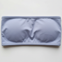 Black backless bandeau sports bra, side view on model.