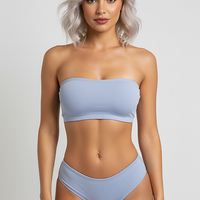 Black backless bandeau sports bra, side view on model.