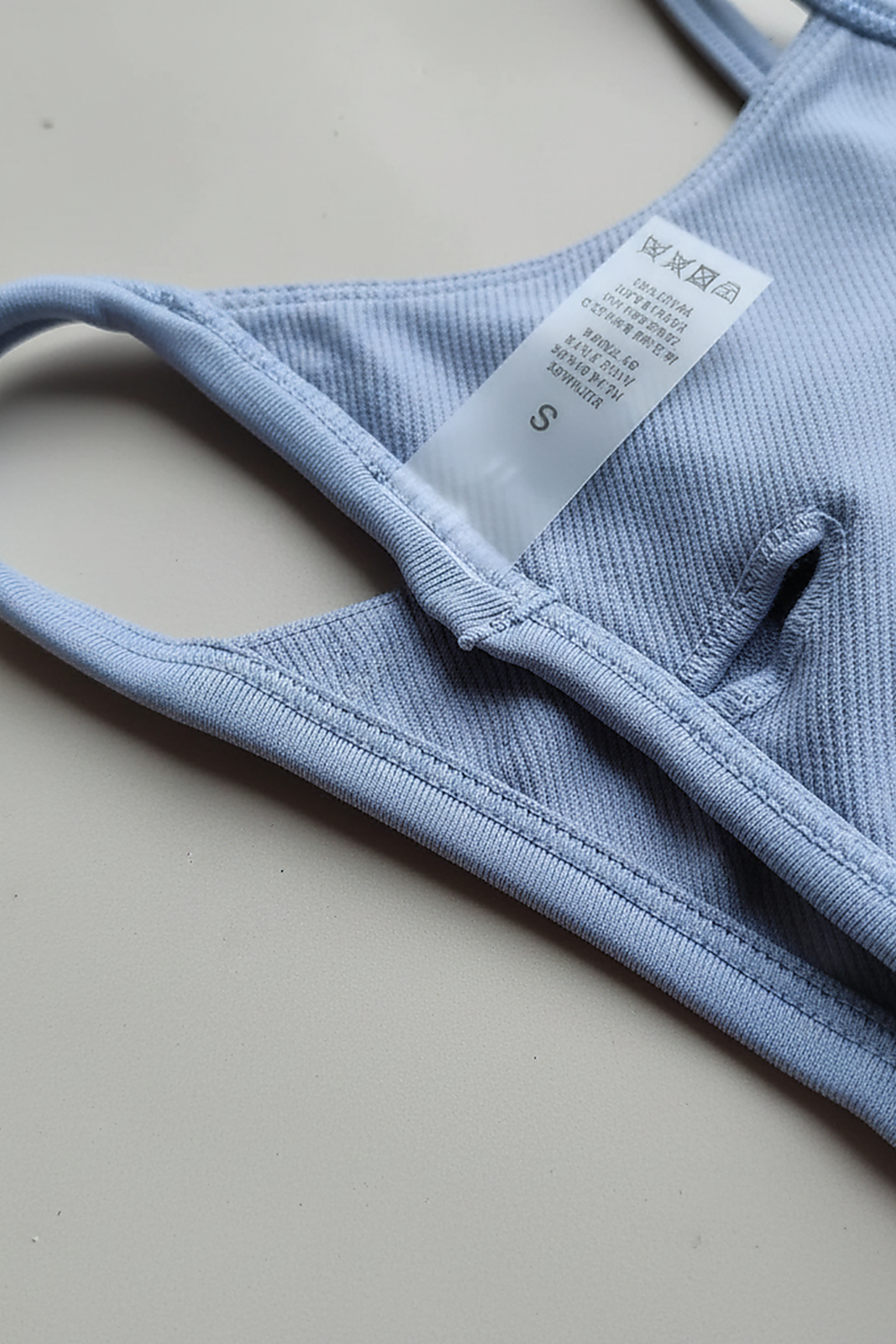 Black backless bandeau sports bra, fabric detail close-up.