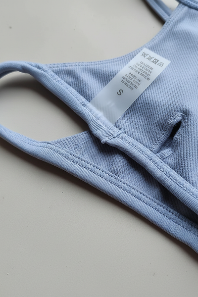 Black backless bandeau sports bra, fabric detail close-up.