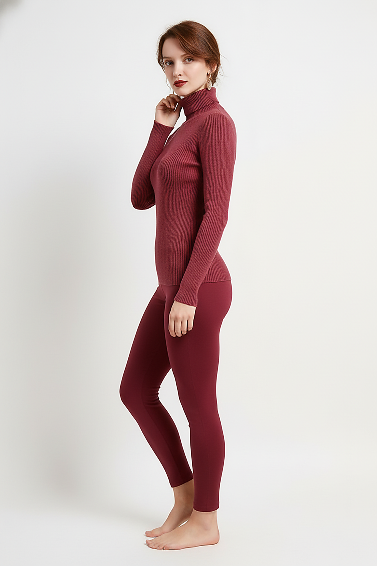 Women's knitted pullover sweater, full length back view on model.