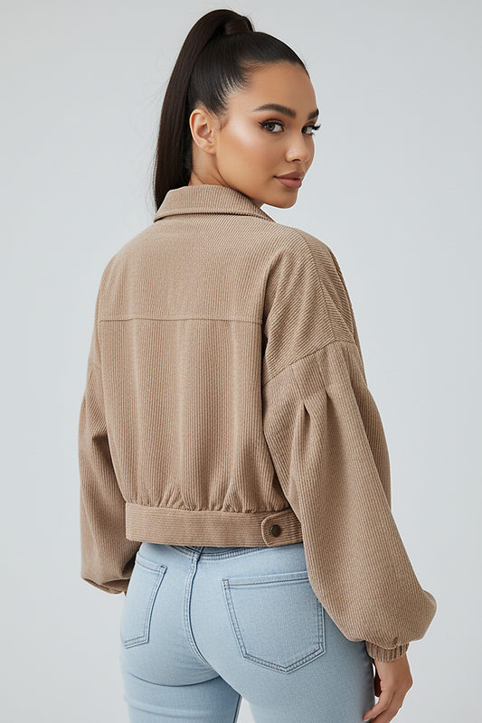 Cropped corduroy jacket, single-breasted, lantern sleeve, side view on model.