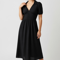 woman wearing tropical print halter neck maxi dress, front view, standing, hands relaxed