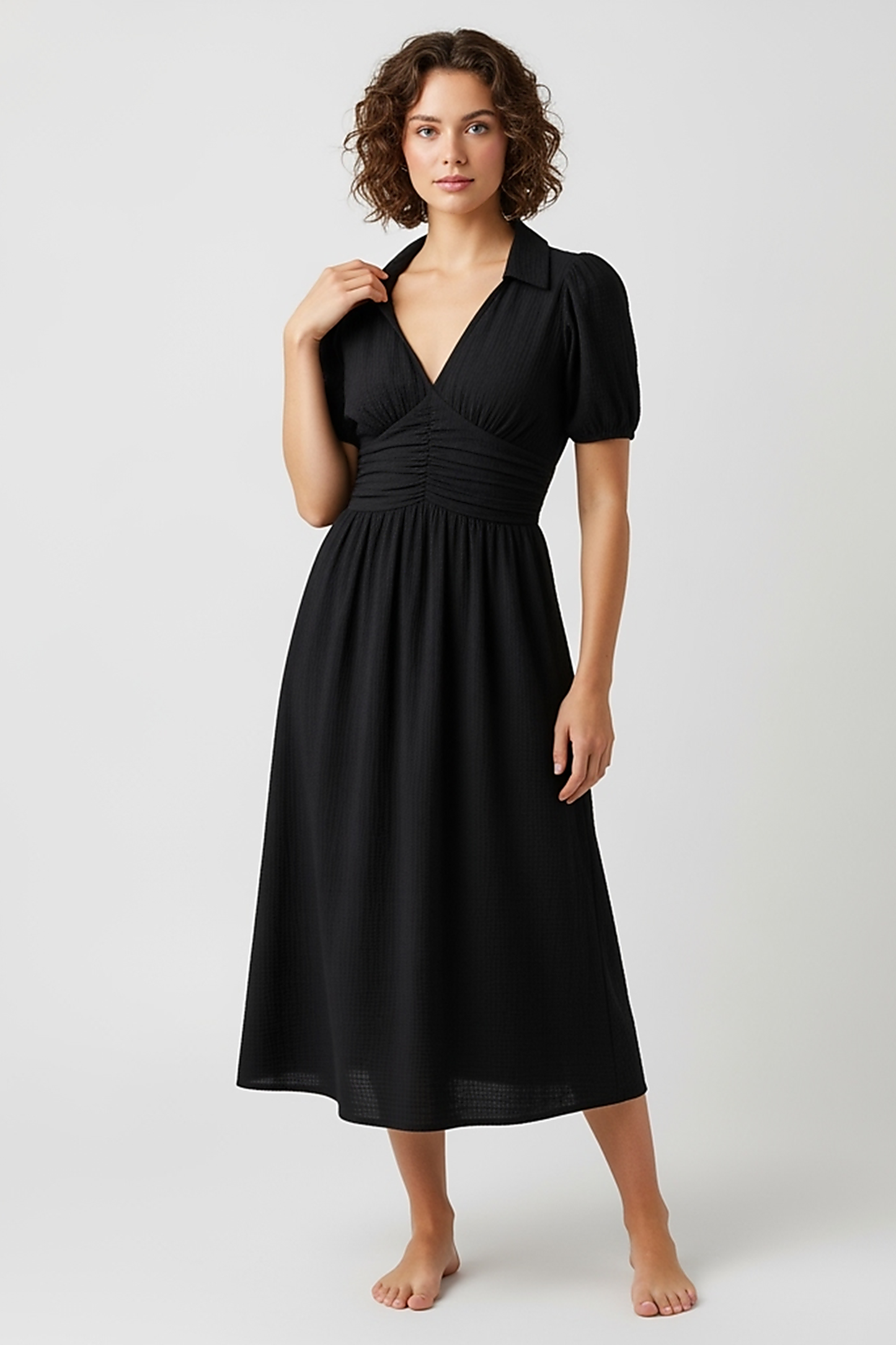 woman wearing tropical print halter neck maxi dress, front view, standing, hands relaxed