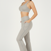 Black bootcut yoga pants, alternate angle view on model.