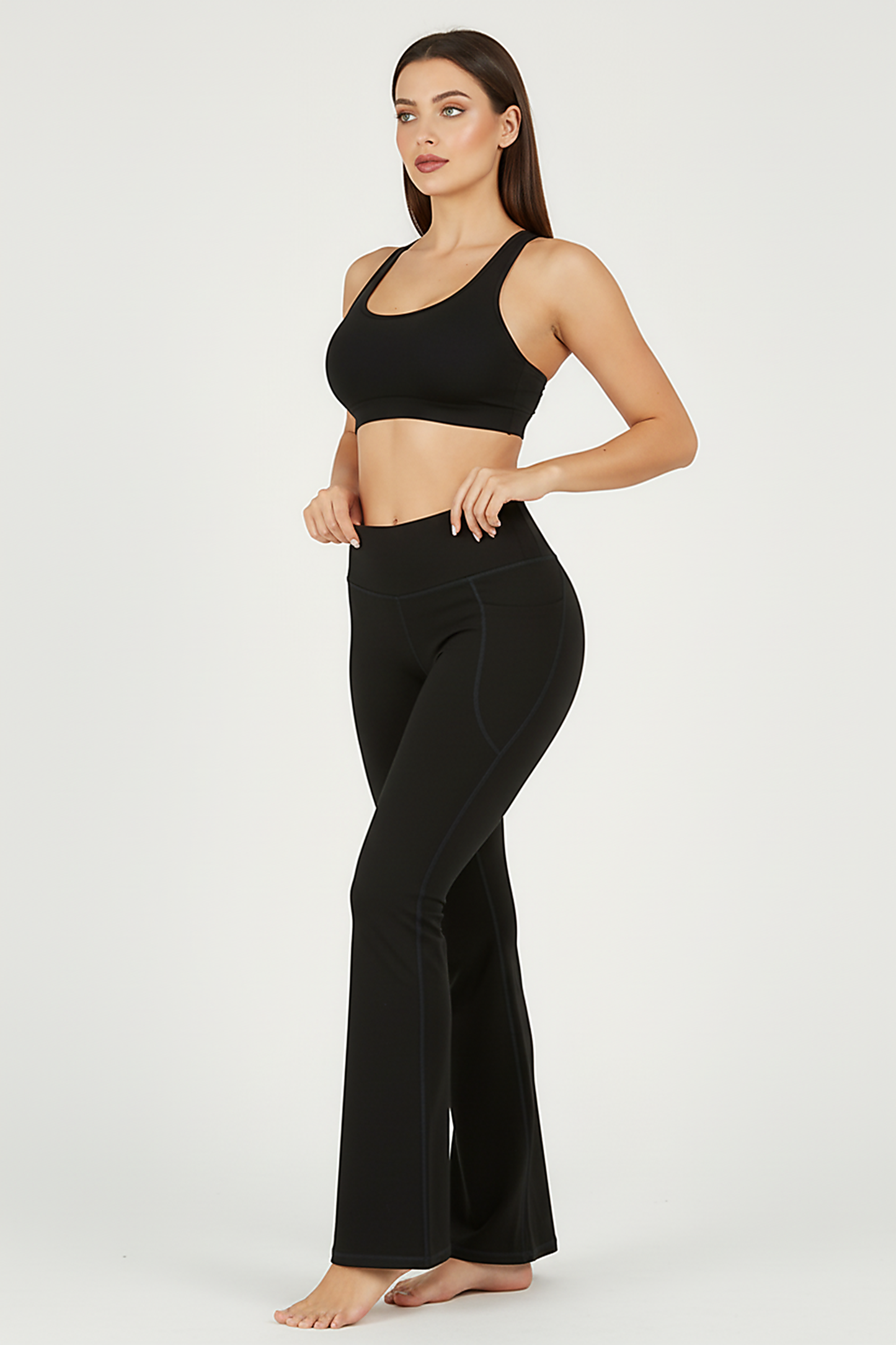 Black bootcut yoga pants, alternate angle view on model.