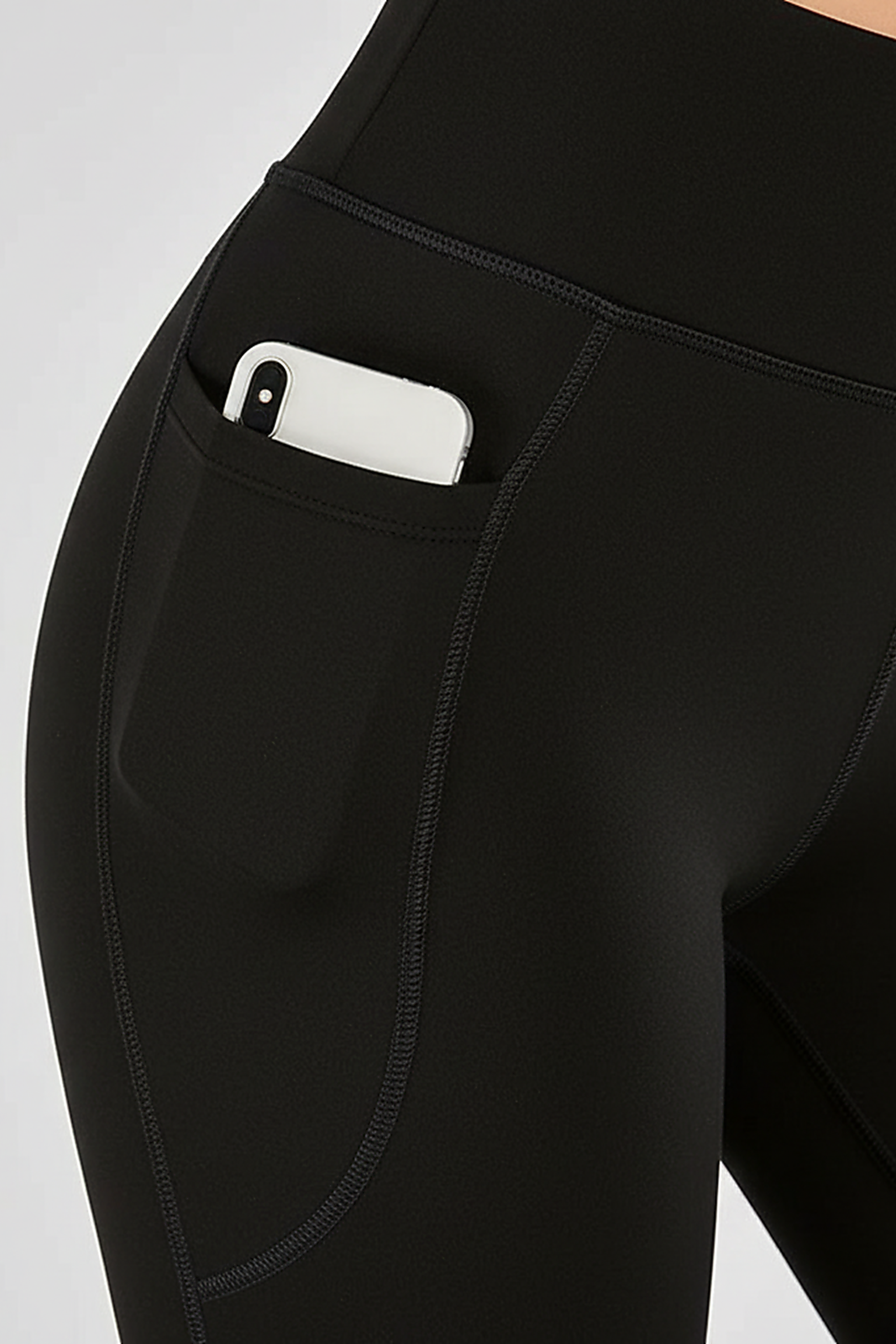 Black bootcut yoga pants, close-up fabric detail.