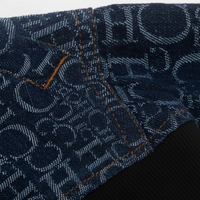 Women's blue denim jacket, side view on model.