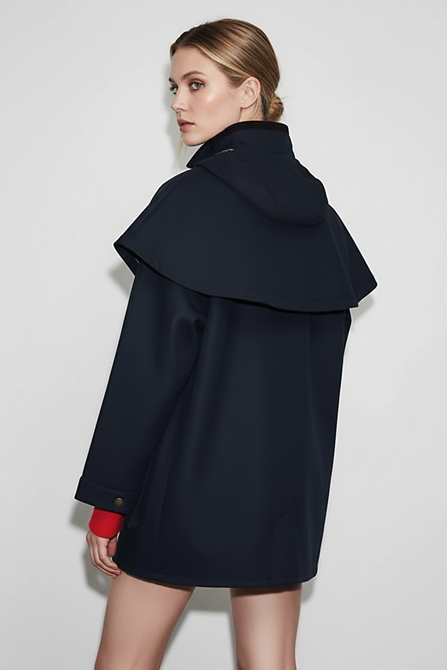 Removable hooded coat, close-up of pockets and zipper.