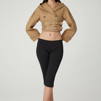 Black hooded crop trench coat, full length view.