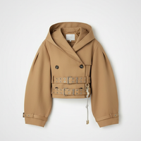 Black hooded crop trench coat, close-up of lapel.