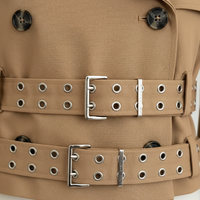 Black hooded crop trench coat, close-up of sleeve.