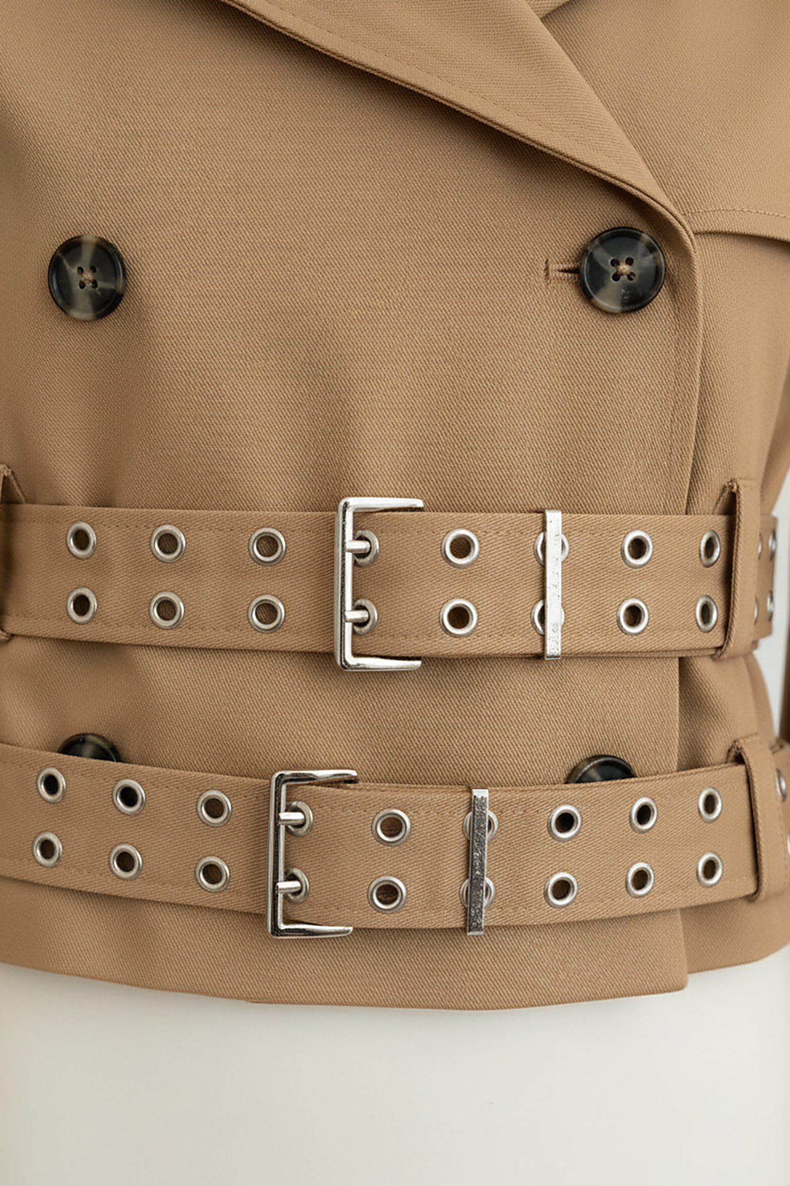 Black hooded crop trench coat, close-up of sleeve.