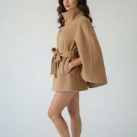 Vintage cape jacket with belt and stand neck detail.