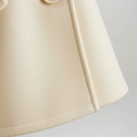 Vintage cape jacket hem detail.