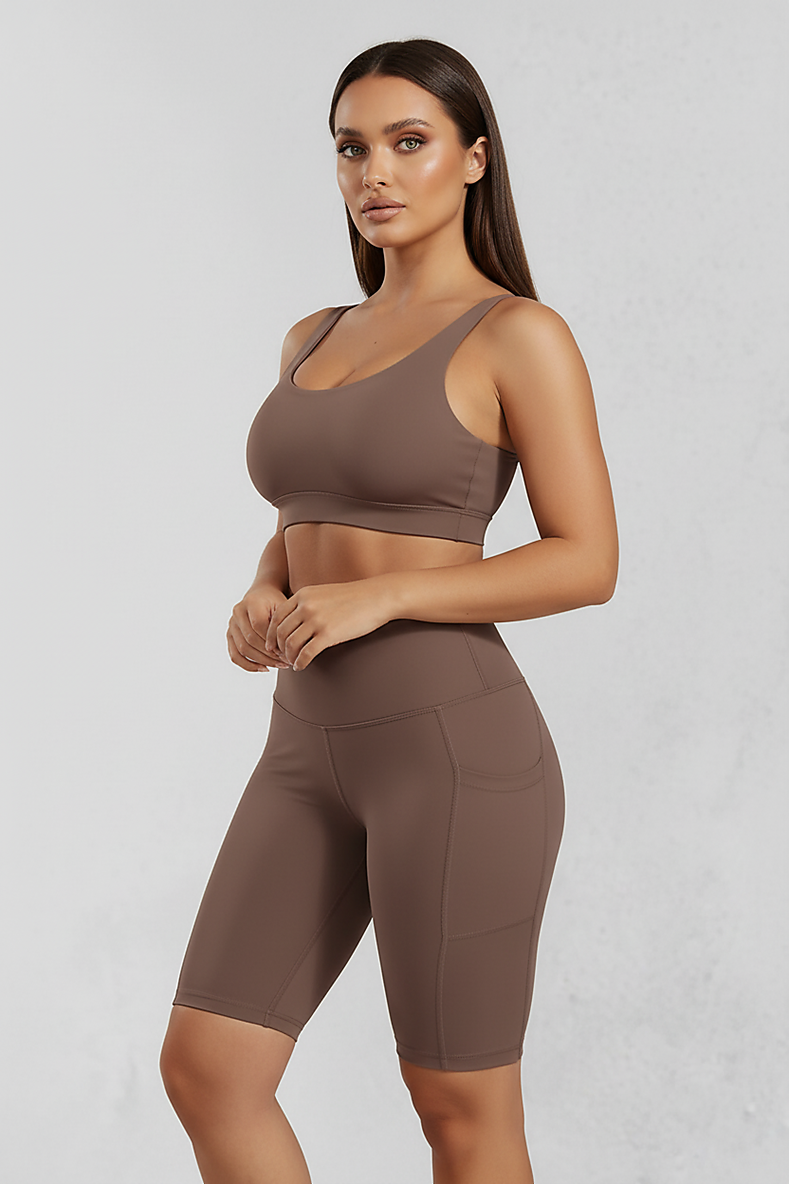 Solid yoga shorts with pockets, alternate angle view on model.