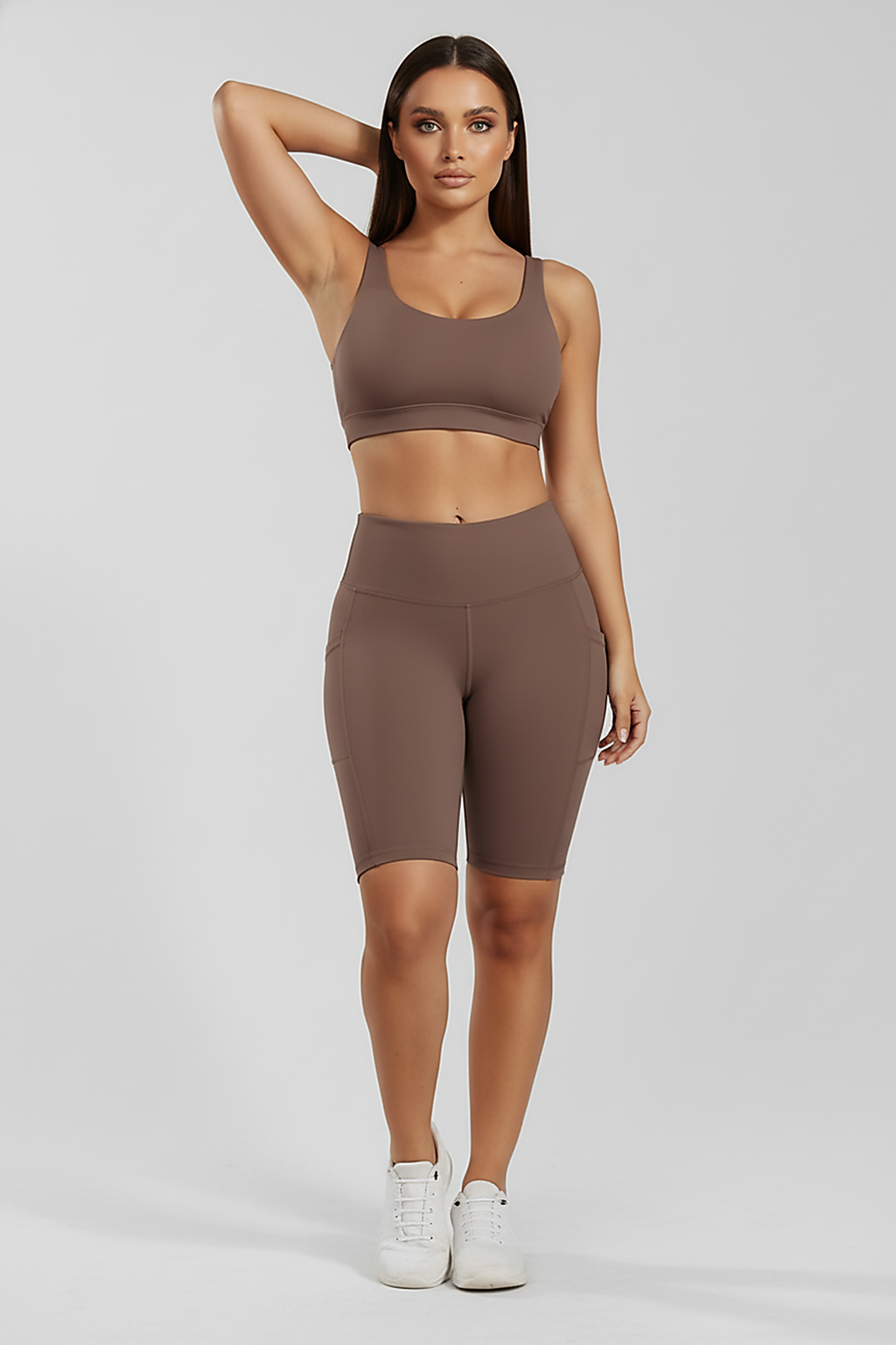 Solid yoga shorts with pockets, alternate angle view on model.