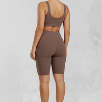 Solid yoga shorts with pockets, back view on model.