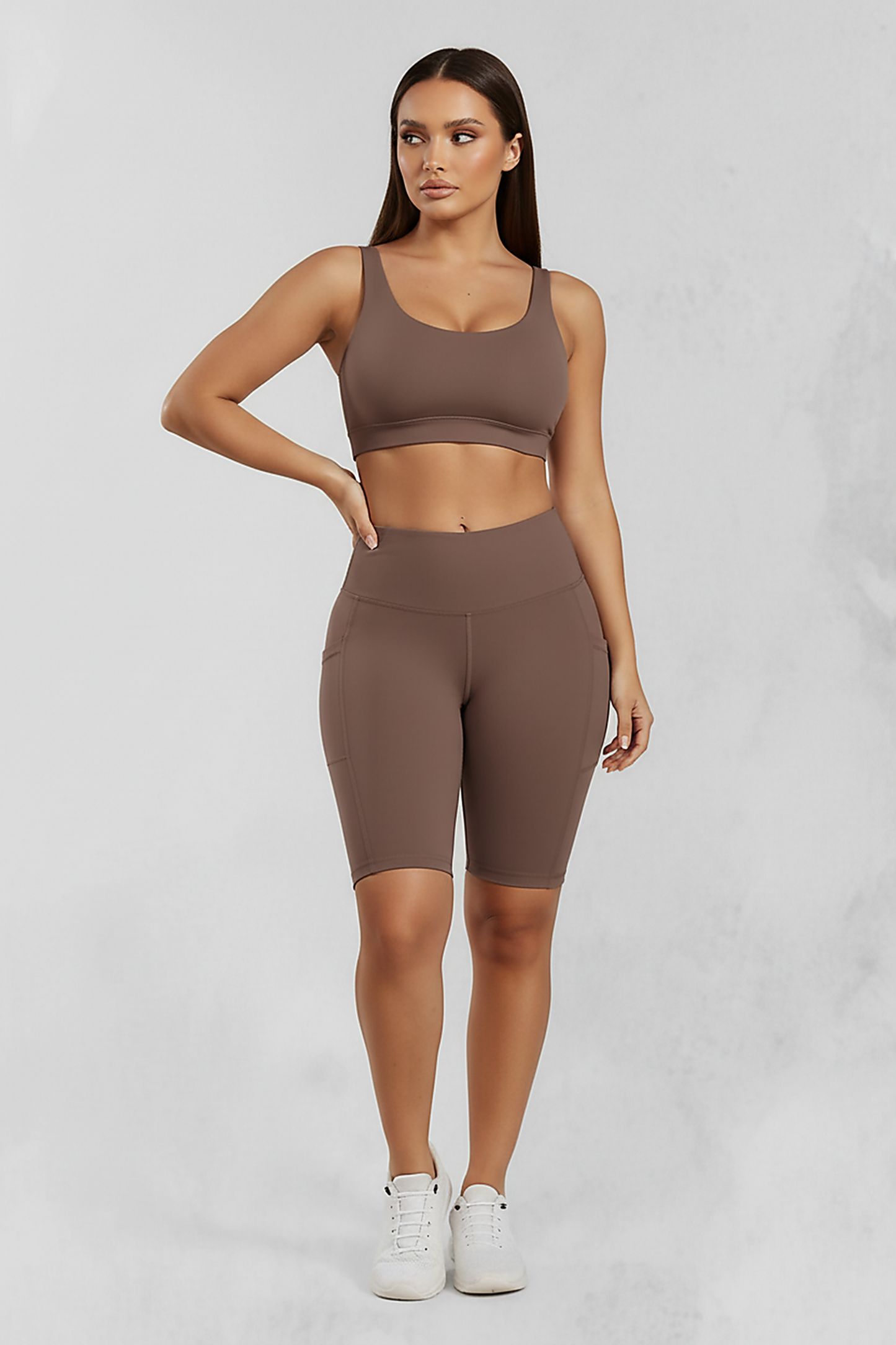 Solid yoga shorts with pockets, front view on model.