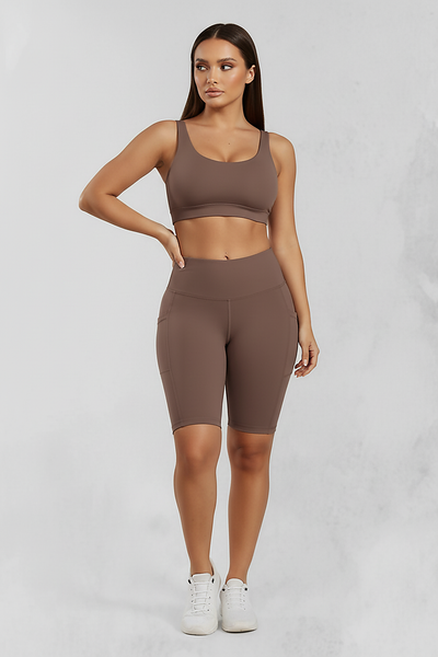 Solid yoga shorts with pockets, front view on model.