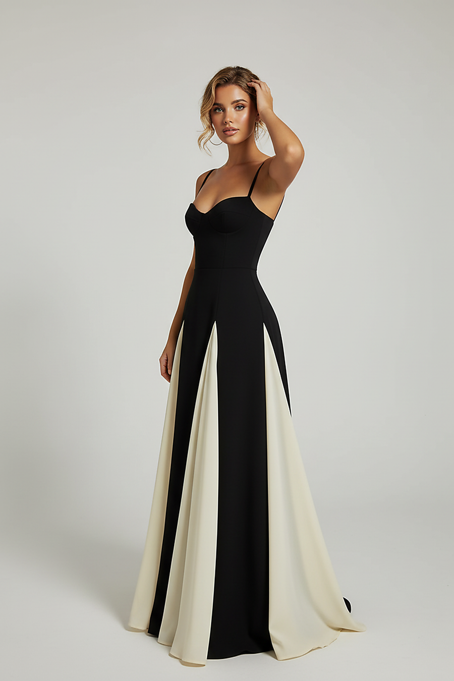 Front view of a woman wearing a black and cream contrast panel maxi gown, with her hand on her hip.; Side profile of a woman in an elegant black and cream A-line evening dress.; Woman in a black