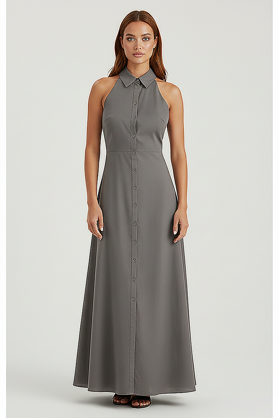 Front view of a woman wearing a dark grey collared halter maxi dress against a white background.; Full length view of a woman wearing a medium grey collared halter maxi dress.; Woman sitting on a