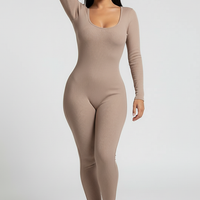 Black long-sleeve bodycon jumpsuit, waist and seam detail.
