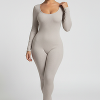 Black long-sleeve bodycon jumpsuit, side view on model.