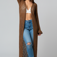 woman wearing black ribbed knit wrap top and matching A-line skirt, front view, standing, hands relaxed