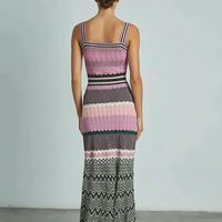 Black sleeveless knitted dress, side view on model.