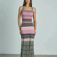 Black sleeveless knitted dress, full length view.