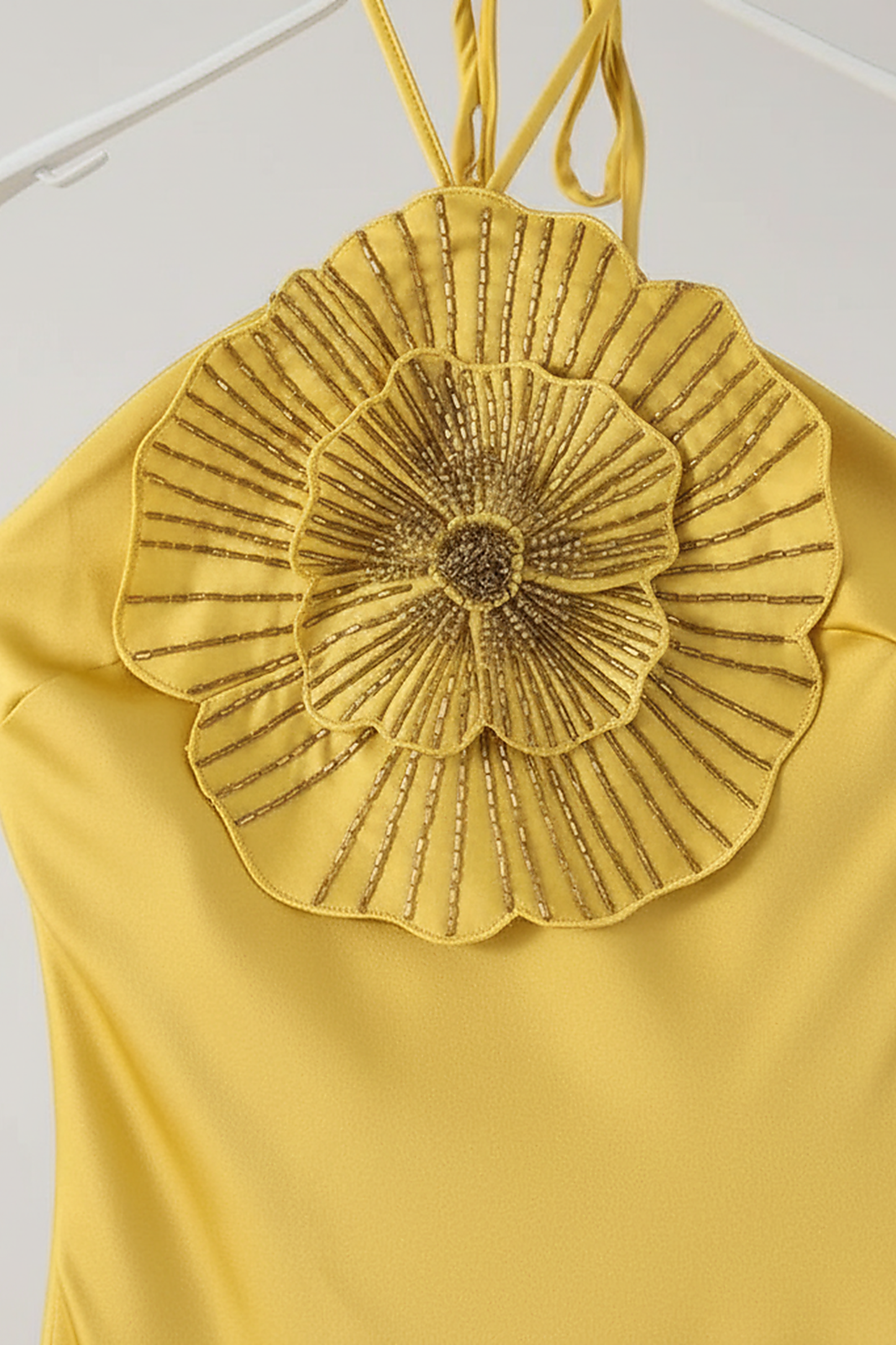 Fabric detail of satin halter mermaid dress.