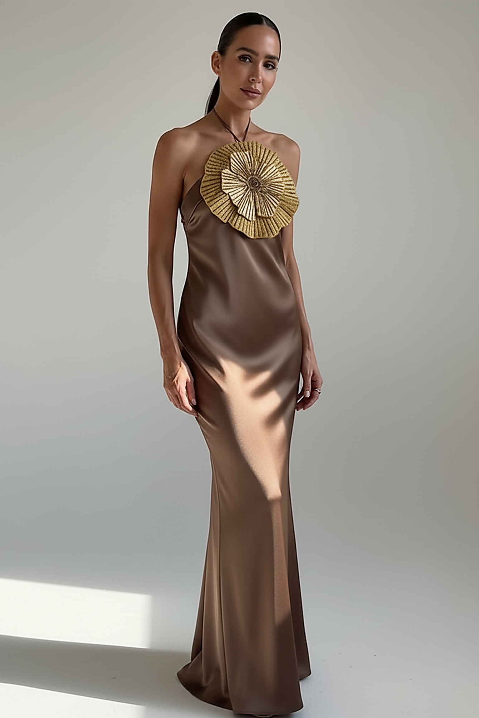 Detail of mermaid hem on halter satin dress.