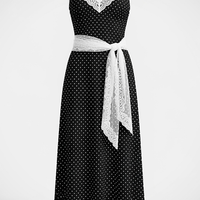 woman wearing polka dot suspender maxi dress, front view, standing, hands relaxed