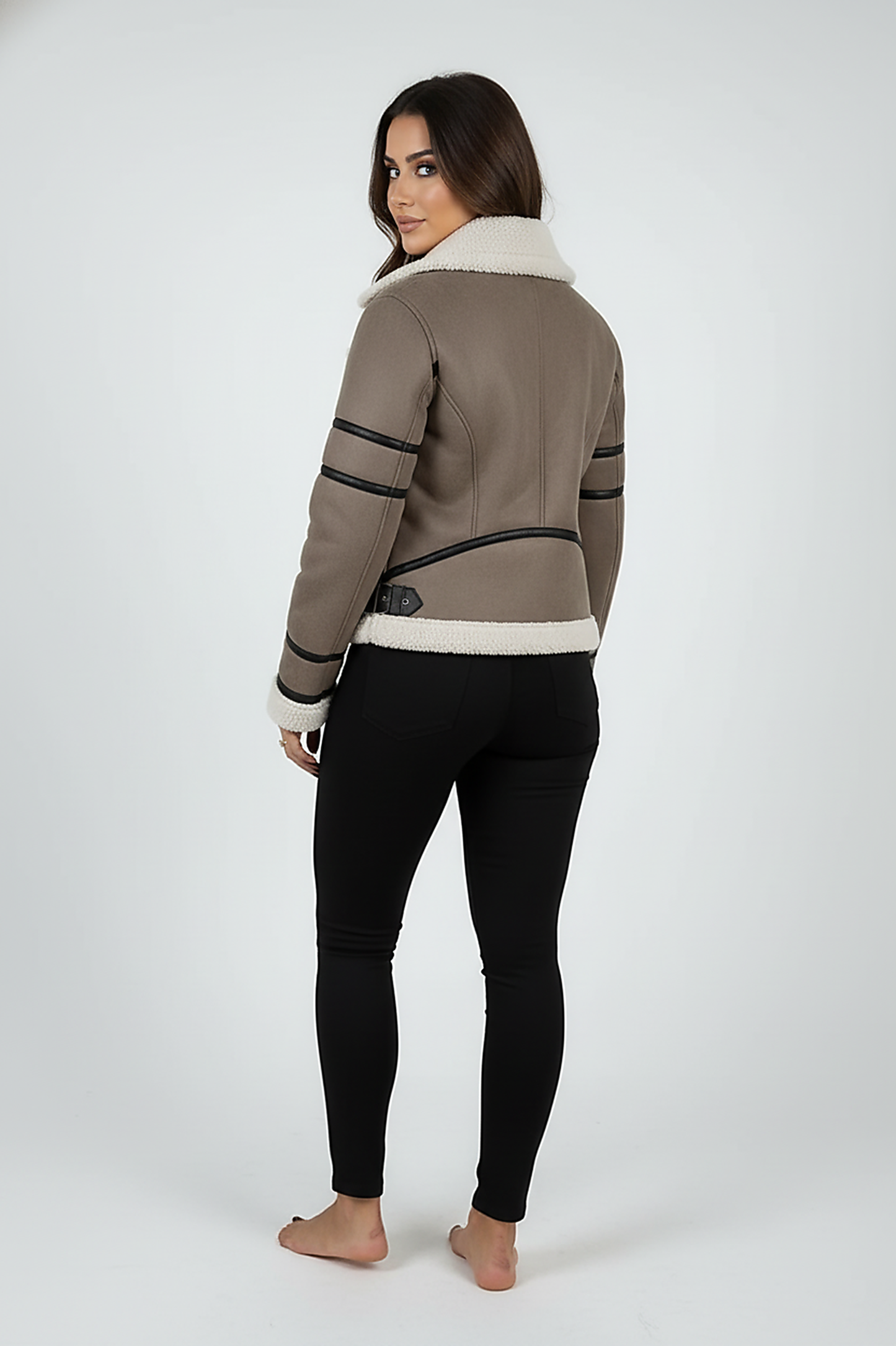 Cream synthetic sheepskin bomber jacket, model in a lifestyle pose.