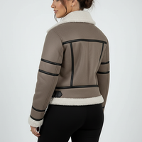 Cream synthetic sheepskin bomber jacket, fabric texture close-up.