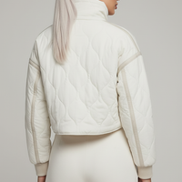 Stand-collar winter jacket, close-up of zipper and drawstring.